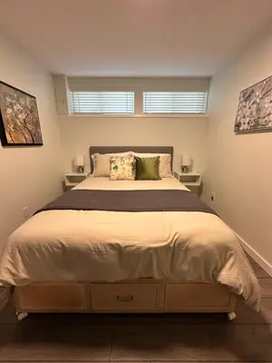a bedroom with a large bed and two windows at Swallow's Perch Guest Suite in Vesuvius