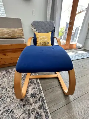 a blue chair sitting in a room with a bed at Swallow's Perch Guest Suite in Vesuvius