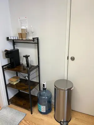 a room with a trash can and a metal shelf at Cozy Escape in the City in Port Coquitlam