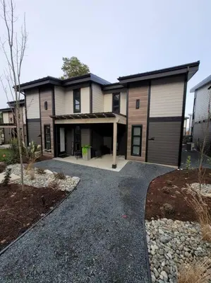 a large house with a garage and a driveway at ENTIRE Sunrise Resort Townhome in Parksville in Parksville