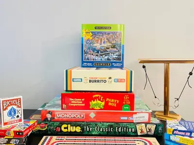 a stack of books sitting on top of a table at ENTIRE Sunrise Resort Townhome in Parksville in Parksville