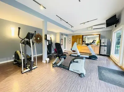 a gym with several exercise equipment in a room at ENTIRE Sunrise Resort Townhome in Parksville in Parksville