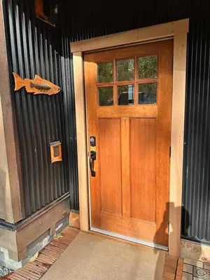 a wooden door on the side of a house at Eagle Way in Port Renfrew