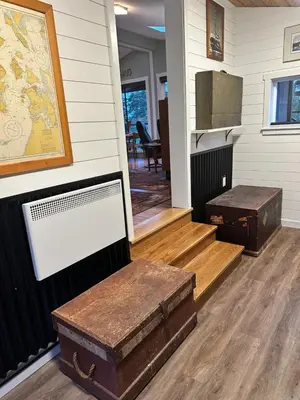 a room with two trunks on the floor and a table at Eagle Way in Port Renfrew