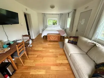 a living room with a couch and a bed at Silva Bay View BnB in Gabriola