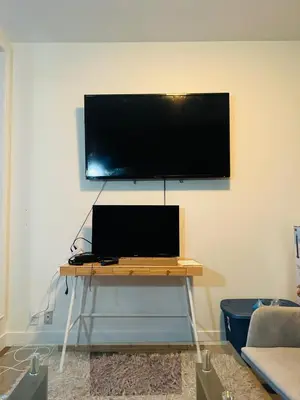 a flat screen tv hanging on a wall at Gorgeous City Views Central Studio Walk to Seawall in Vancouver