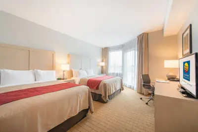 a hotel room with two beds and a flat screen tv at Comfort Inn & Suites in Campbell River