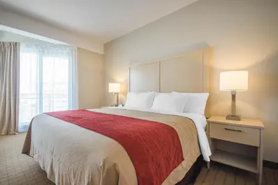a hotel room with a large bed with two lamps at Comfort Inn & Suites in Campbell River