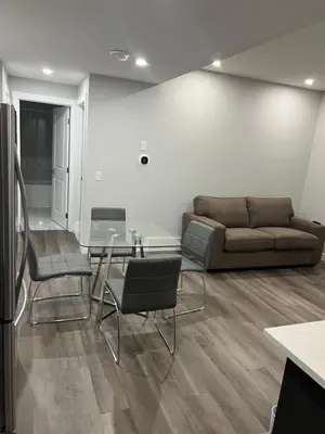 a living room with a couch and a glass table at Beautiful suite in Balzac