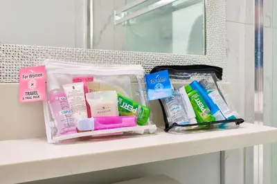 a shelf with toothbrushes and other bathroom items on it at Basement Suite In Vancouver in Vancouver