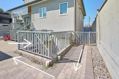 a building with a staircase in front of a house at Basement Suite In Vancouver in Vancouver