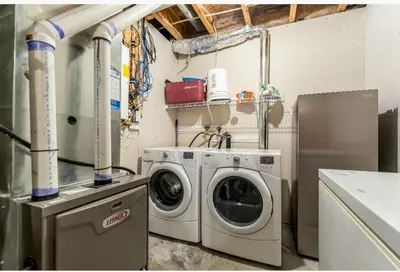 a laundry room with a washing machine and a washer at Basement Apartment in Calgary