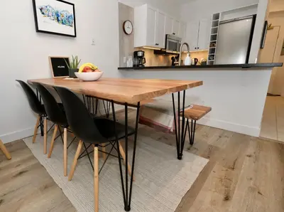 a kitchen with a wooden table and black chairs at Whistler Village 2BR 2BA Top-Floor Condo with Hot Tub and Parking in Whistler