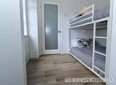 a bedroom with a bunk bed and a mirror at Whistler Village 2BR 2BA Top-Floor Condo with Hot Tub and Parking in Whistler