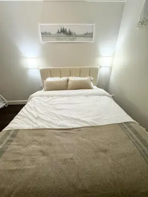 a bedroom with a large white bed with two pillows at Cozy 1BR Near Skytrain - Explore Vancouver Easily in Vancouver