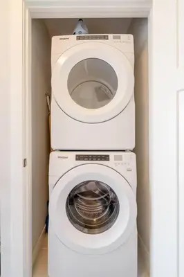 a white washer and dryer in a room at Exquisite One Bedroom Apartment in NW in Calgary