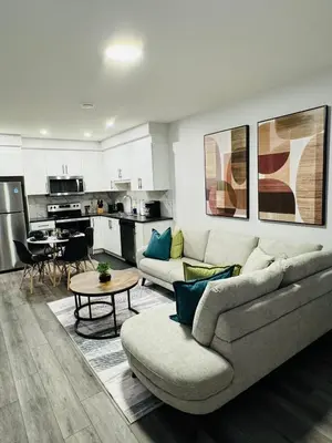 a living room with a couch and a table at The Glacier Royale - 1 Bed Suite in NW Calgary in Calgary