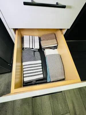 a drawer filled with towels in a kitchen drawer at The Glacier Royale - 1 Bed Suite in NW Calgary in Calgary