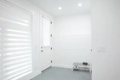 a room with a white wall and a door at New Luxury Walkout Suite Near University-BY ROOM in Calgary