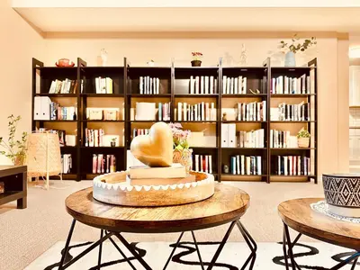 a room with a table with a chair and a book shelf at Scorpio House Langley - Semi-basement Suite in Langley
