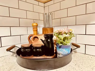 a tray with some utensils and flowers on a counter at Scorpio House Langley - Semi-basement Suite in Langley