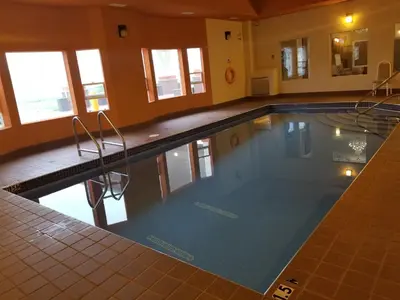 a large swimming pool in a building at New Imperial Suites in Whitecourt