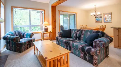 a living room with a couch and a coffee table at Stone Creek Chalet by Fernie Lodging Company in Fernie