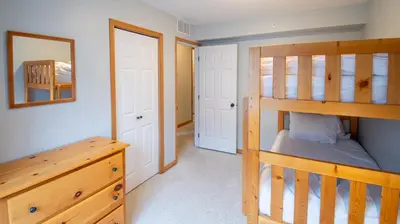 a bedroom with a bunk bed and a dresser in a room at Stone Creek Chalet by Fernie Lodging Company in Fernie