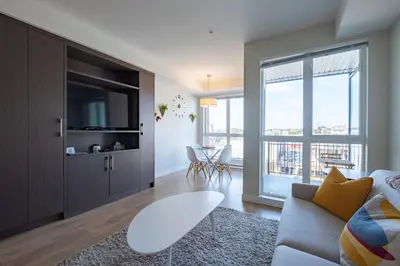 a living room with a couch and a tv at Stylish Modern Apartment In The Heart Of Old Town Victoria in Victoria