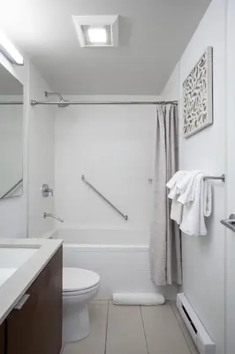 a white bathroom with a toilet and a sink at Chic And Cozy Apartment In Old Town in Victoria