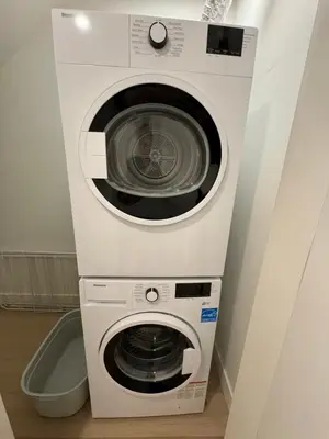 a white washer and dryer in a room at Central Moodyville Retreat in North Vancouver