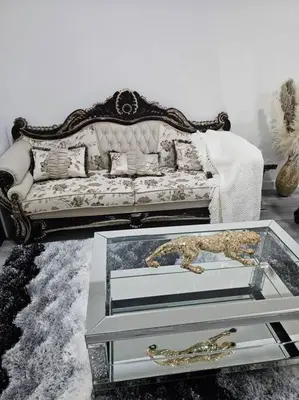 a living room with a couch and a glass table at Comfort Guest Suite NE Calgary - Near Airport in Calgary