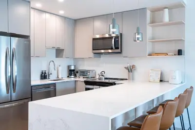 a kitchen with white cabinets and a white counter top at Mountain Revelation by Revelstoke Vacations in Revelstoke
