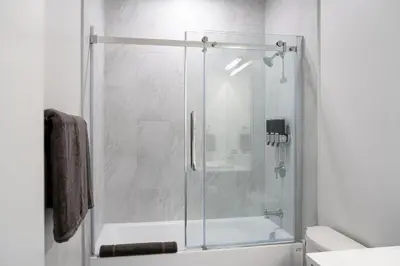 a shower with a glass door in a bathroom at Mountain Revelation by Revelstoke Vacations in Revelstoke