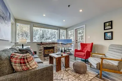 a living room with a couch and a fireplace at Greystone Lodge 329 Ski-in Out in Whistler