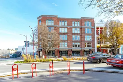 a street with red barriers in front of a building at Chic And Cozy Condo In Old Town Victoria in Victoria