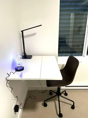 a white desk with a chair and a lamp on it at Brand new suite in langley close to everything in Langley