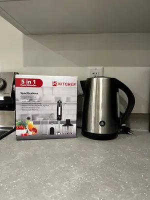 a tea kettle next to a box on a counter at Brand new suite in langley close to everything in Langley