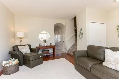 a living room with a couch and a chair at Spacious 3bedrm for family or business travellers in Red Deer