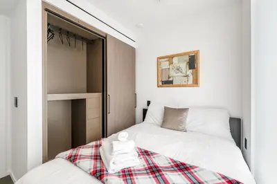 a small bedroom with a bed and a closet at Luxury High-Rise Condo with Stunning Views in Vancouver