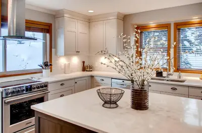 a kitchen with a vase of flowers on a counter at Moonshine Crescent 385 by Okanagan Premier in Big White