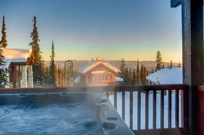 a hot tub on the balcony of a house at Moonshine Crescent 385 by Okanagan Premier in Big White