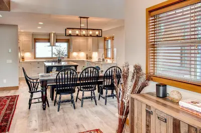 a kitchen and dining room with a table and chairs at Moonshine Crescent 385 by Okanagan Premier in Big White