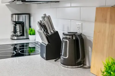 a kitchen counter with a coffee maker and utensils at Modern Studio Unit - Close to DT in Edmonton