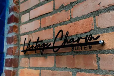 a sign on the side of a brick wall at Stylish downtown apartment in Grand Forks, BC in Grand Forks