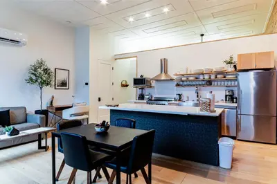 a kitchen and living room with a table and chairs at Modern industrial suite in Grand Forks in Grand Forks
