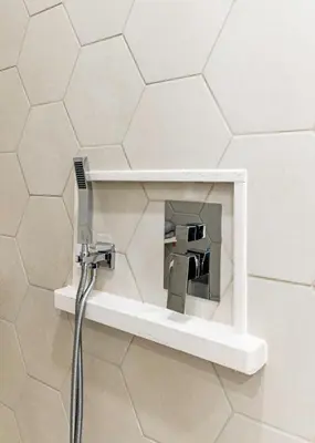 a shower in a bathroom with a shower head at Modern industrial suite in Grand Forks in Grand Forks