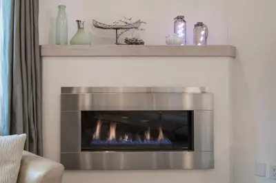 a fireplace in a living room with a fire place at Christina Lake Lakefront, Hot Tub, Amazing Views in Christina Lake