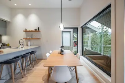a kitchen with a wooden table and chairs at Blueberry Hill Estates 3144 by Outpost Whistler in Whistler