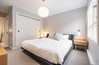 a bedroom with a bed and a large window at Blueberry Hill Estates 3144 by Outpost Whistler in Whistler